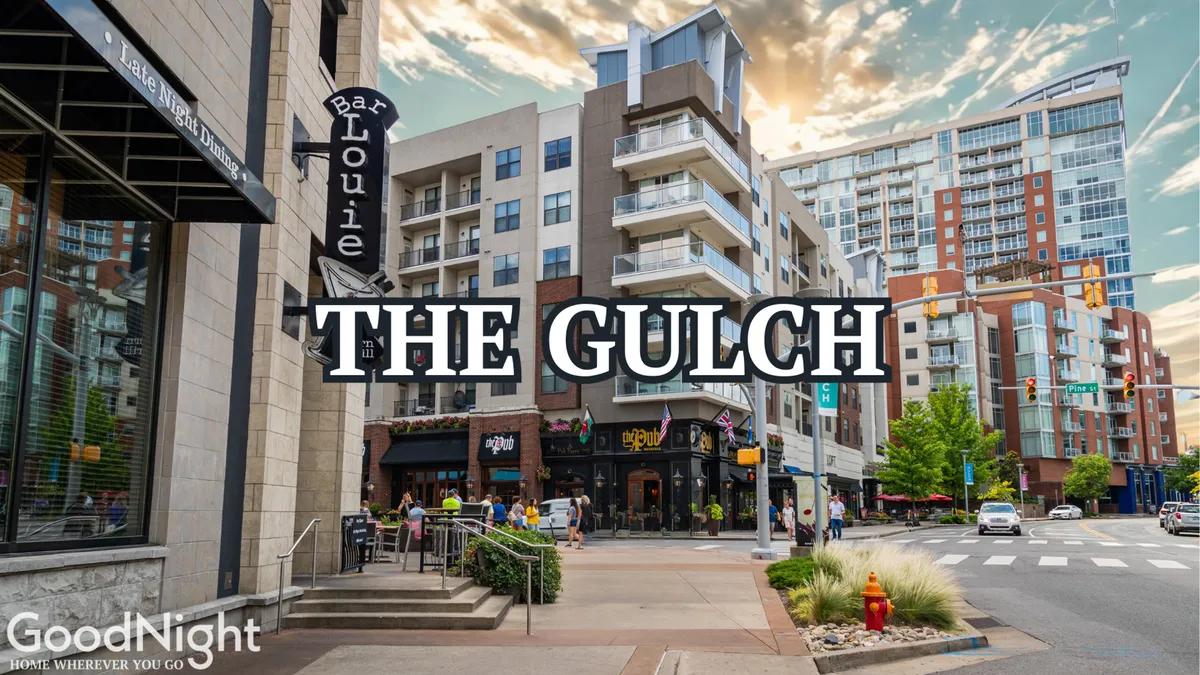 An energetic street scene featuring the Bar Louie signage, modern apartment buildings, bustling pedestrian activity, and commercial establishments. The image conveys the lively spirit and urban vibe of Midtown Nashville, highlighting its vibrant dining and entertainment scene.